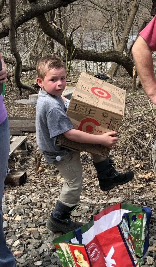 Young boy carrying a Target donation box outdoors